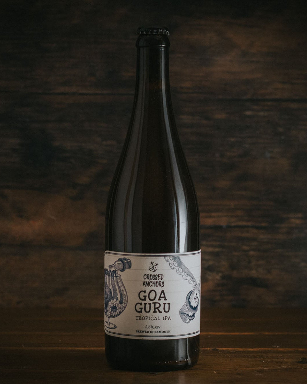 A bottle of Crossed Anchors Goa Guru Tropical IPA.